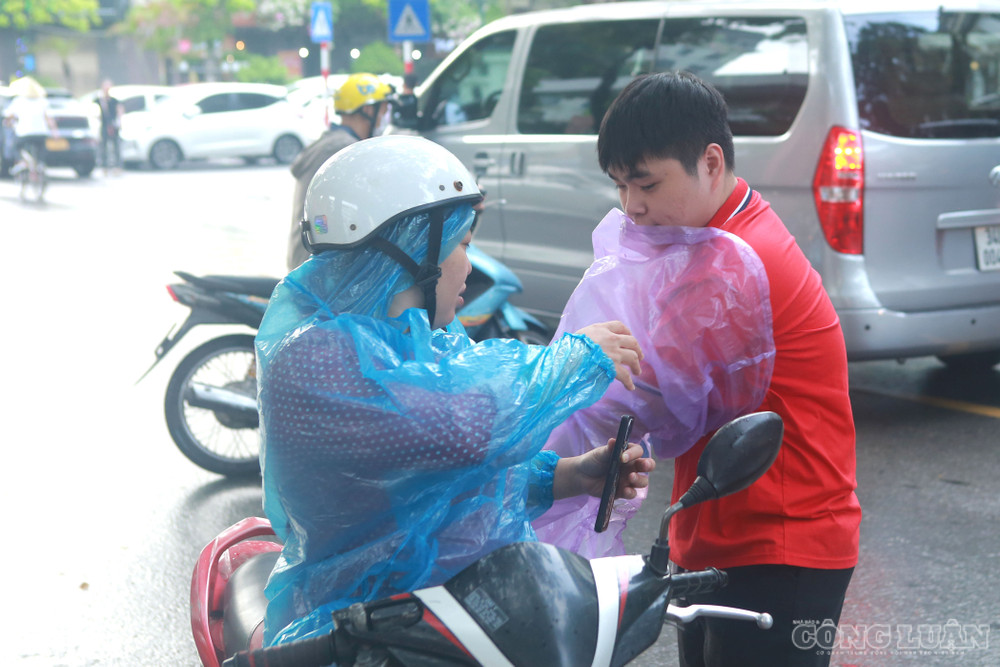 Do thời tiết có mưa nhỏ, không ít gia đình sử dụng xe máy và mặc áo mưa để kịp đưa con đến trường đúng giờ. clo_br_2.jpg